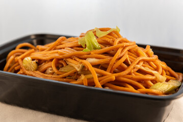 Large bowl of chow mein shows the sheen of sweet sauce noodles