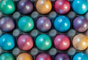 Easter background with hand painted purple, blue, green, orange