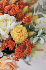 autumn flowers. orange, yellow, white flowers and green leaves together. groom boutonniere