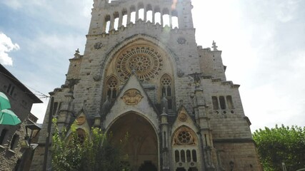 4k Church of Saint Bartholomew facing the east side of Placa is flanked by ajuntament and Banco de Soller, Catalan architect Joan Rubio i Bellver. Soller, Mallorca, in Balearic Islands of Spain.
B
