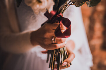 Wedding bouquet in bride's hands in white dress