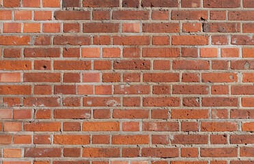 Texture of a brick wall after repair some bricks. The real texture of a building from the last century.