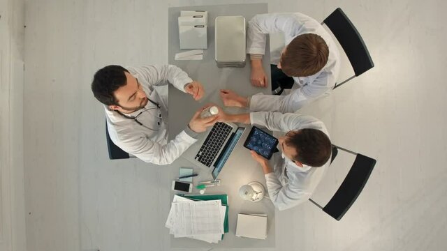 Timelapse Hospital, medical education, health care, people and medicine concept - group of happy doctors with tablet pc computers meeting at medical office. Top view