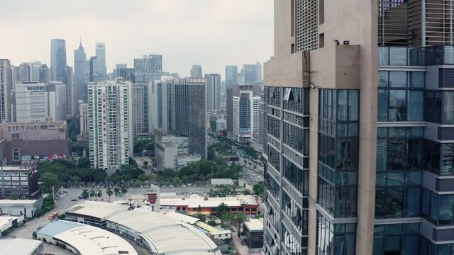 Fly by near office buildings with view on Guangzhou downtown office building area  in background.China.