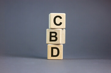 Wood cubes with acronym 'CBD' - 'customer business development'  on beautiful grey background, copy space. Business concept.