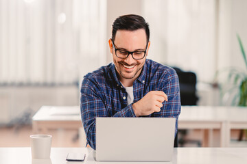 Businessman working in the office with a smile on his face