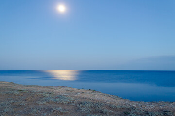 Fototapeta na wymiar full moon over the sea, view from the cliff