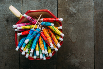 Various Color Cocktail Paper Umbrellas in a Ceramic Cup