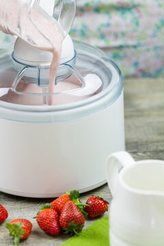 Ice cream maker machine making strawberry ice cream