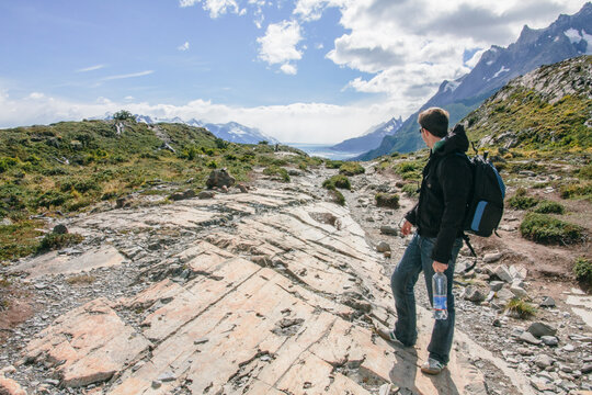 Young man in mountain landscape of Patagonia. Torres del Paine National park, Chile