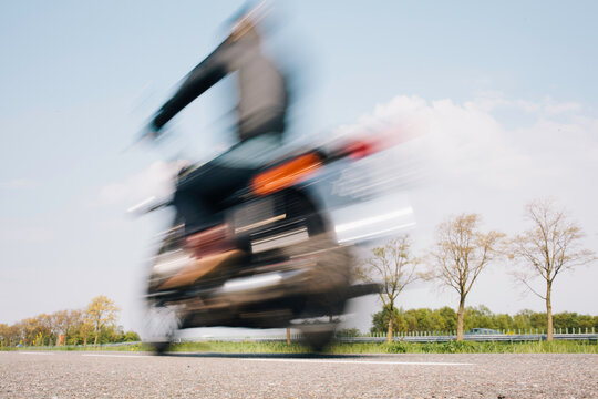 Blurry image of a rider or a motorcyclist on a classic motor