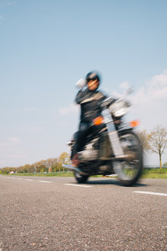 Blurry image of a rider or a motorcyclist on a classic motor