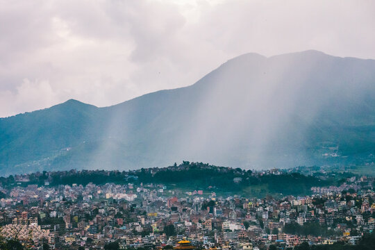 City buildings and mountain with sunlight rays - Kathmandu, Nepal