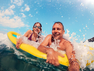 Father and daughter having fun on the beach