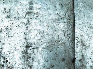 texture, metallic background with coloring. the metal sheet is corroded. holes on the metal, damage, cuts. there are nails on the texture, corrosion, rust