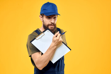 Man in working form documents transportation delivery service yellow background