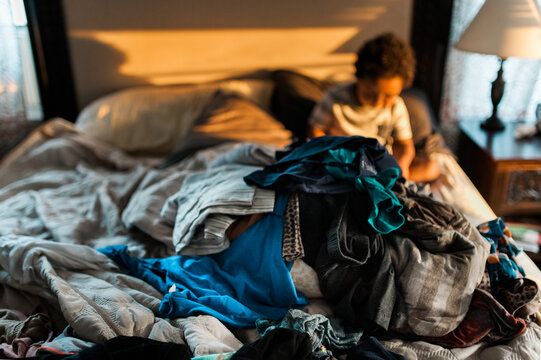 pile of laundry to be done on a bed