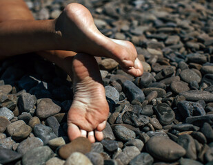 Beautiful young legs on the rocks 