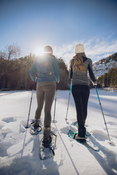 Two friends snowshoeing or cross-country skiing in a beautiful mountain scene