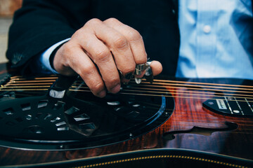 Closeup of A Male Musician's Hands Playing Slide Guitar