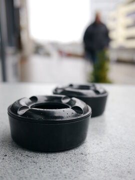 two black ashtray standing table