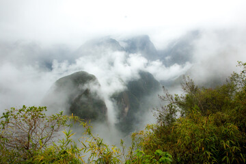 View of the Andes mountains and fog from the Inca trail near Macchu Picchu, Peru.