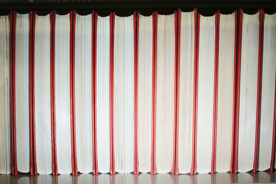 Closeup of a row of hardcover books on a bookshelf