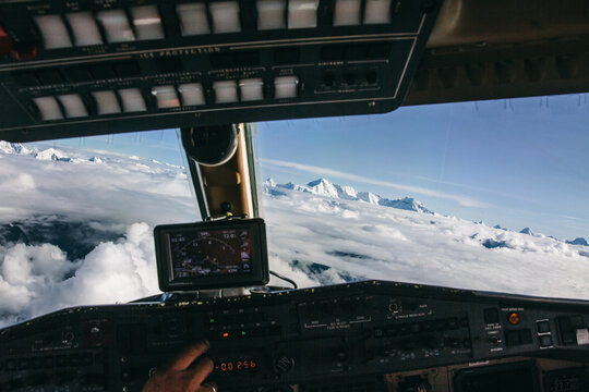 Aircraft cockpit on a flight over Himalaya mountain range with Mount Everest on the background