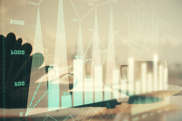 Double exposure of financial chart drawing and desktop with coffee and items on table background. Concept of forex market trading