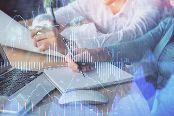 Double exposure of forex chart drawing over people taking notes background. Concept of financial analysis