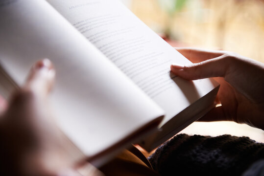 Female hands holding book open