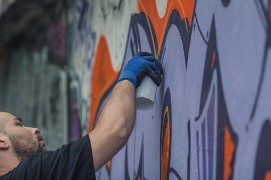 graffiti artist writes on the wall
