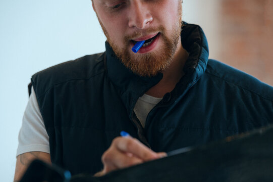 Portrait of man taking notes at office