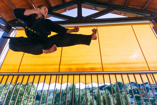 Man doing a flying kick during a martial arts training
