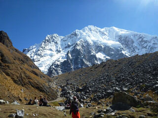 Fototapeta premium Hikers on the Salkantay trek in Peru, with snow capped mountains in the distance