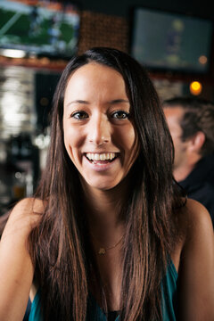 Portrait: Woman Smiles To Camera As If On Video Chat