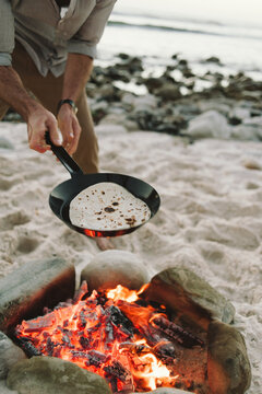 Cooking a soft shell taco on the beach