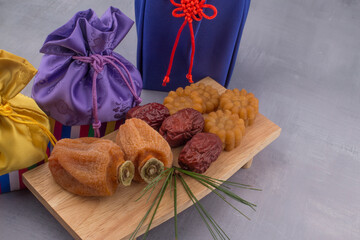 Korean dried persimmon and lucky bag background.