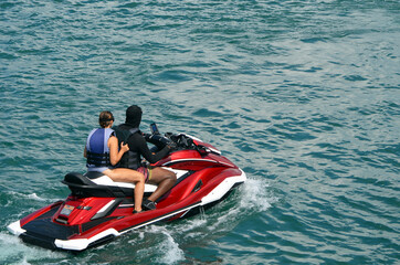 Fototapeta premium Man and a woman riding tandem on a jetski.