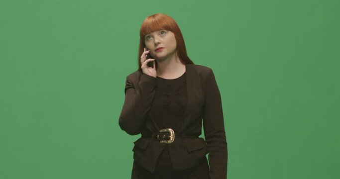 Studio, slow motion, green screen, a serious young woman on the phone, London, UK