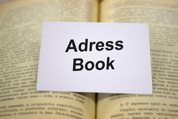 Adress books written in white note on open books