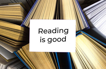 Reading is good written in white note on open books