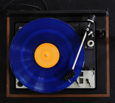 Vintage turntable with a blue record playing