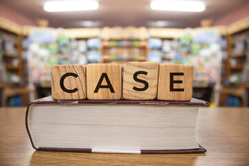 Case words on wooden blocks on book with bluered backround