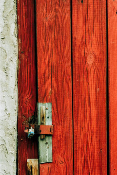 Red door texture with a padlock