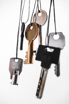 Some keys hanging on white.
