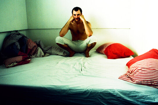 Man sitting on his Bed