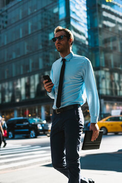Young businessman walking in the street in New York City