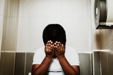 African american boy sad crying at toilet in school.Sex harassment.No racism No bully at...