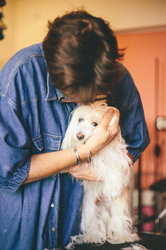 Woman peting a scared dog